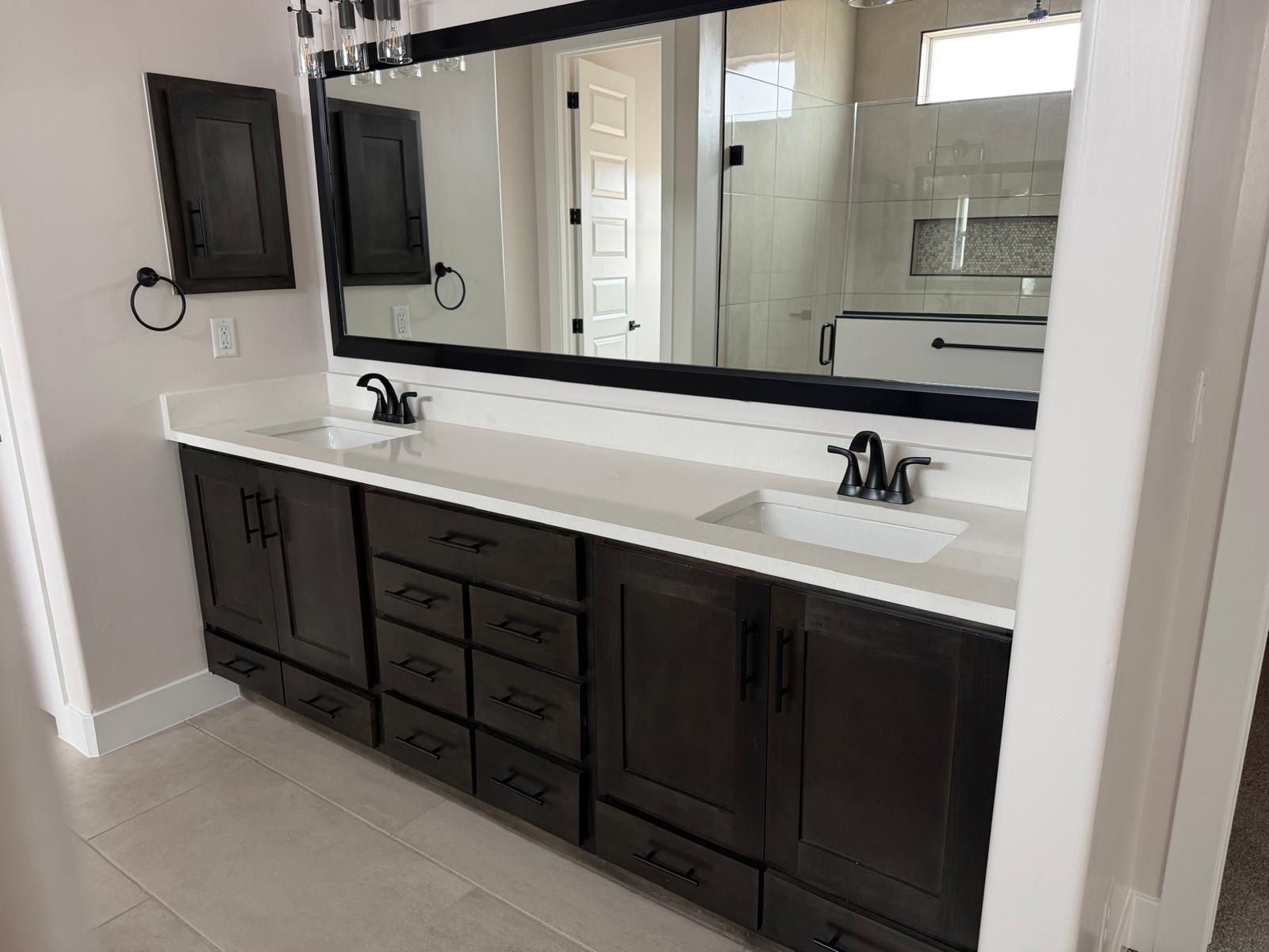 Dark stained wood double vanity with quartz countertop