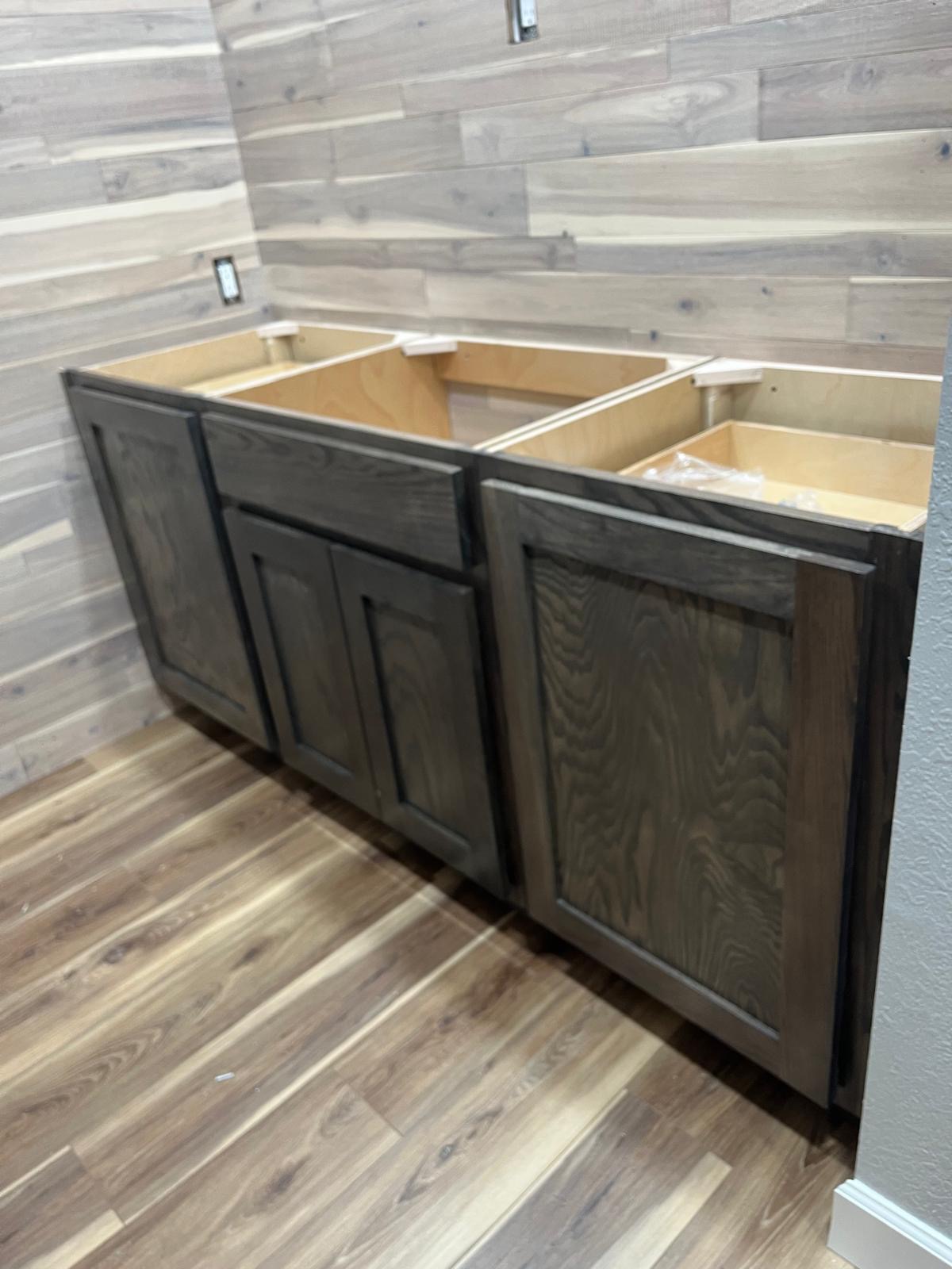Stained wood base cabinets during a kitchen cabinet installation
