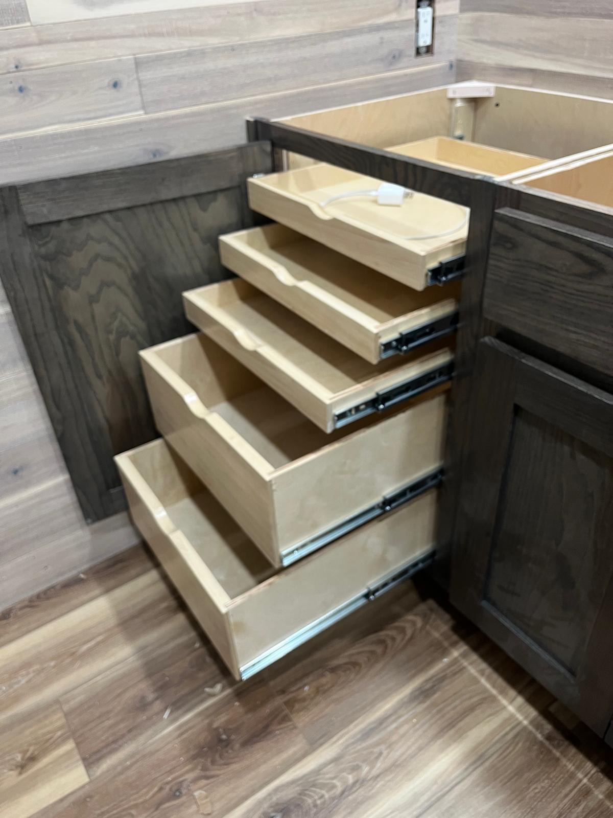 Stained wood cabinet with maple roll-out shelves